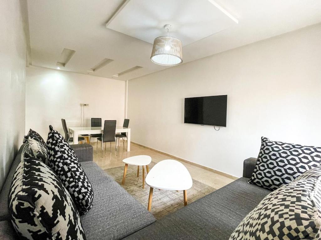 a living room with a couch and a tv at luxury Aprt2 bedrooms Pool hivernage heart of city in Marrakech