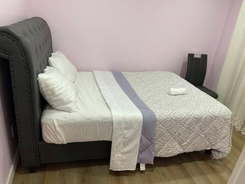 a bedroom with a bed with a white blanket at Bedroom in Upland D in Edmonton