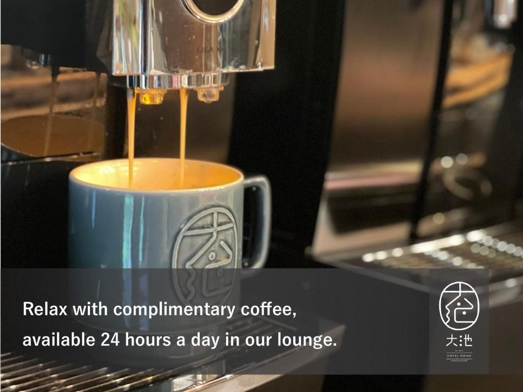 a coffee maker is making a cup of coffee at Oike Hotel in Fujikawaguchiko