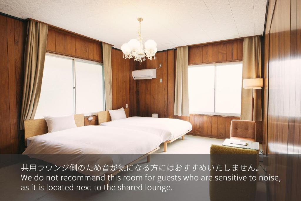 Postel nebo postele na pokoji v ubytování Hanaguri-しまなみ海道スマート旅館