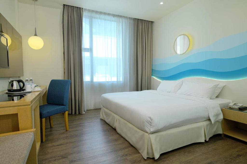 Postel nebo postele na pokoji v ubytování Oceania Hotel