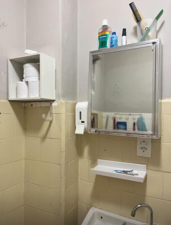 a bathroom with a mirror and a sink at Studio no Largo da Carioca - Rio de Janeiro in Rio de Janeiro