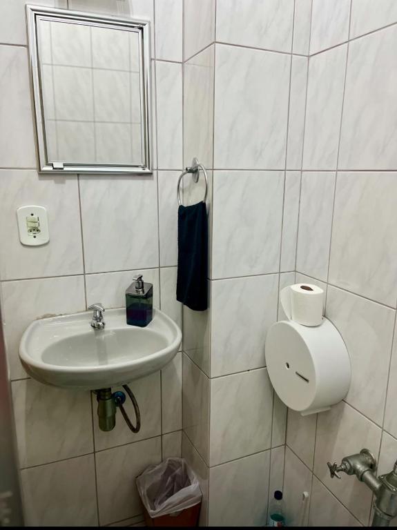 a bathroom with a sink and a mirror at Studio no Largo da Carioca - Rio de Janeiro in Rio de Janeiro
