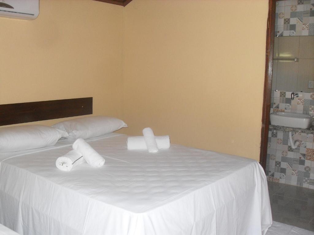 Uma cama ou camas num quarto em Pousada Raio de Luz