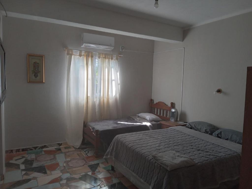 Postel nebo postele na pokoji v ubytování Alojamiento Luci