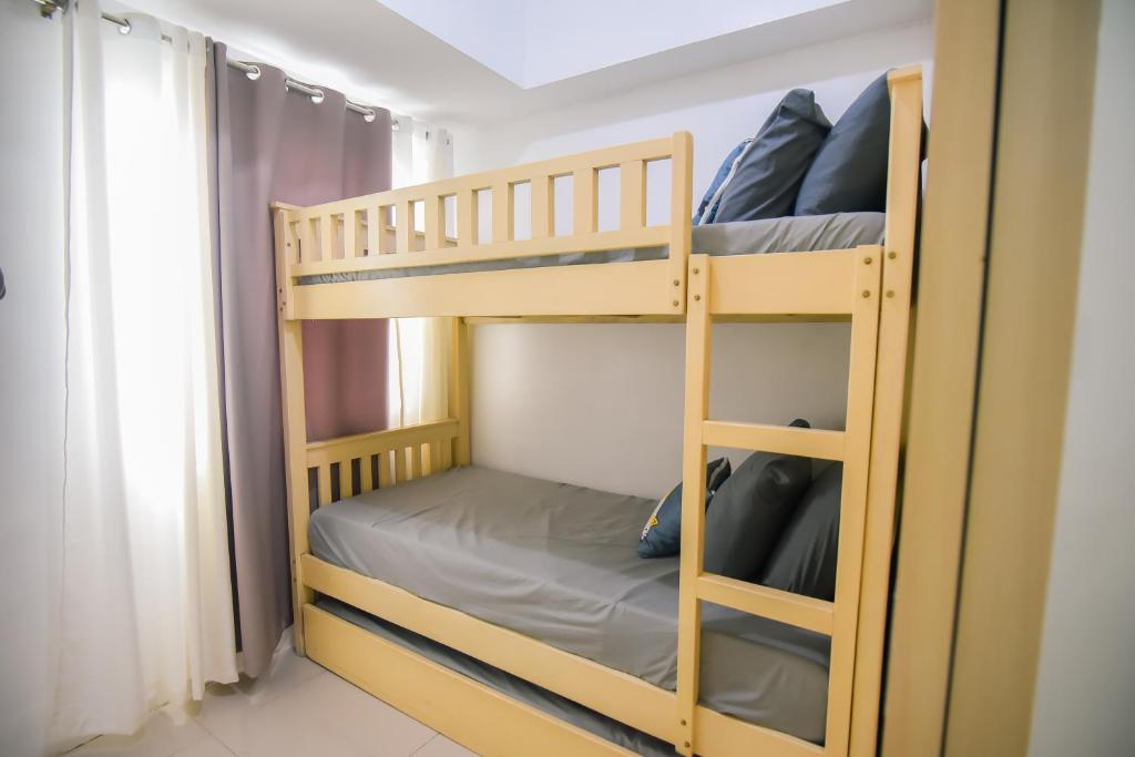 Ένα ή περισσότερα κρεβάτια σε δωμάτιο στο Cozy Place for 8 persons at Grass Residences