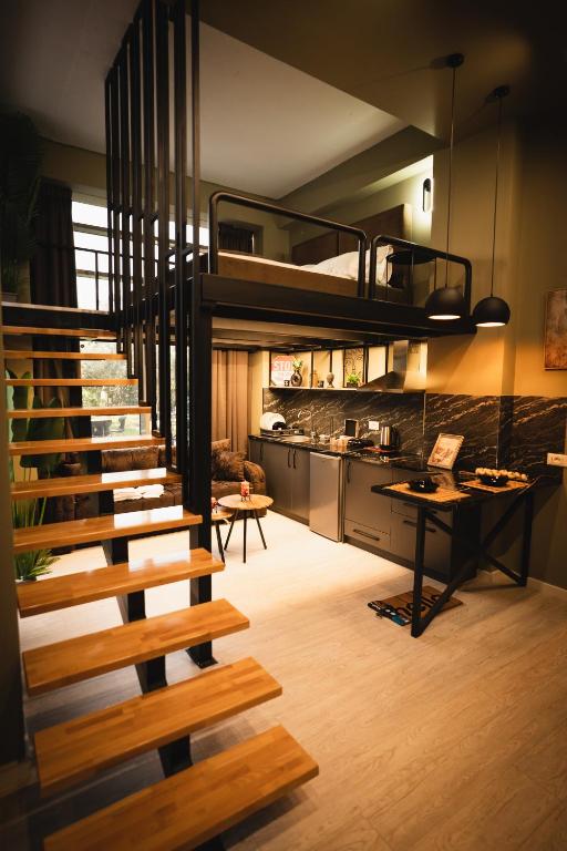 a loft bed in a kitchen with a staircase at Sdluxurystudio in Durrës