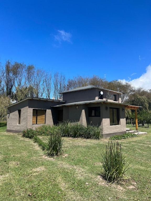 a small house sitting on top of a grass field at Rest has name Sonko in Tafí del Valle