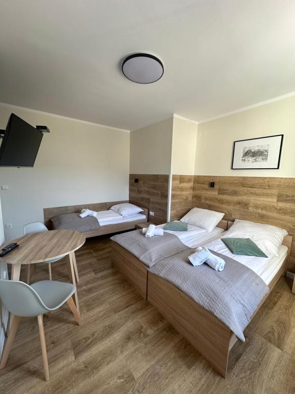 Posteľ alebo postele v izbe v ubytovaní Apartament, Pokoje Koniczynka