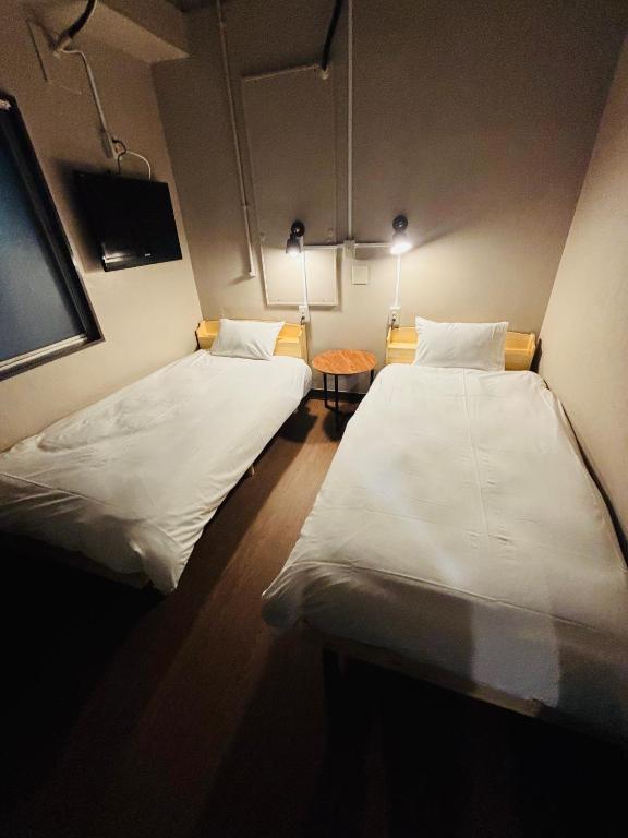 Postel nebo postele na pokoji v ubytování Wasabi Mita Hotel