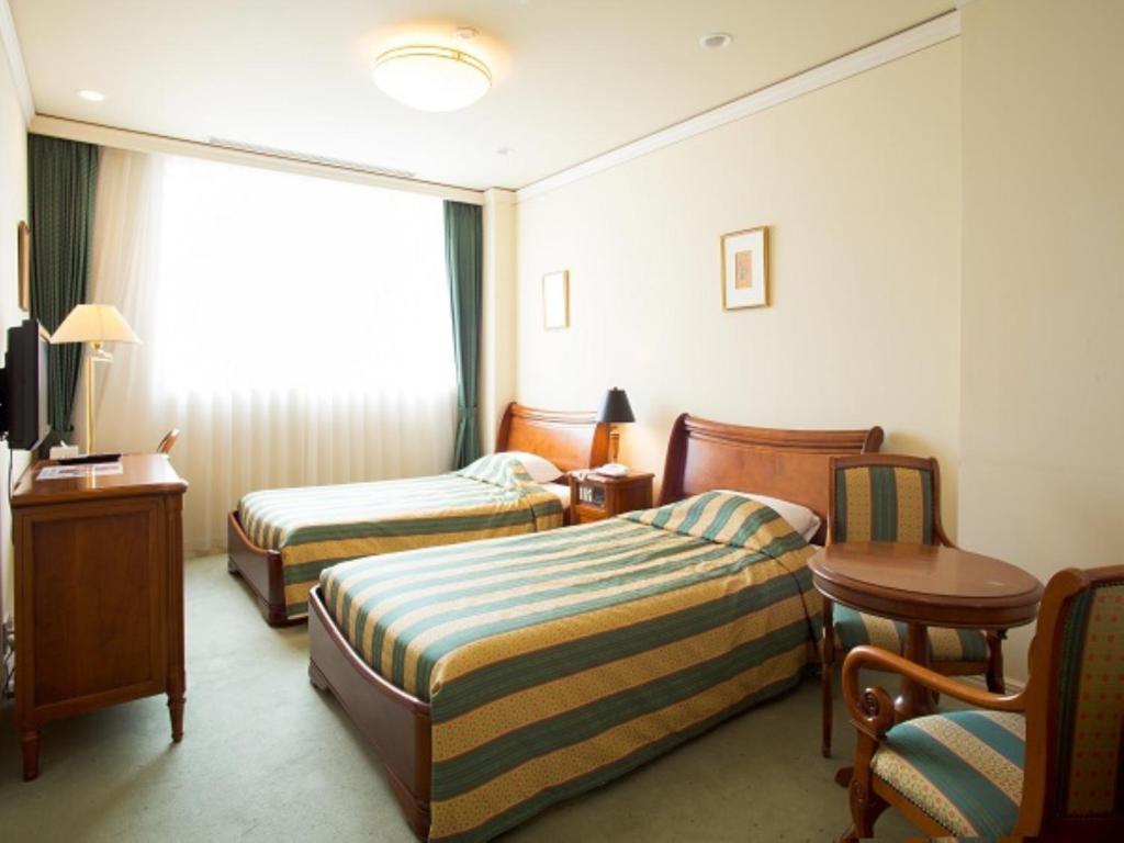 Postel nebo postele na pokoji v ubytování Hotel Marital Sousei Kurume