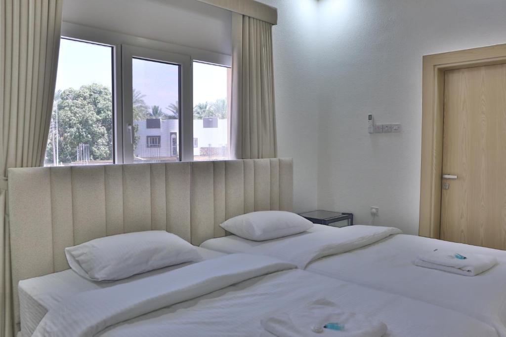 Postel nebo postele na pokoji v ubytování Darunique Inn