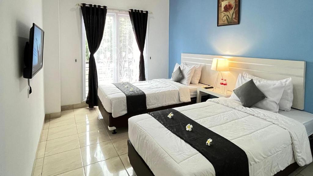 Postel nebo postele na pokoji v ubytování TOS Hotel & Convention Center Tangerang Powered by Archipelago