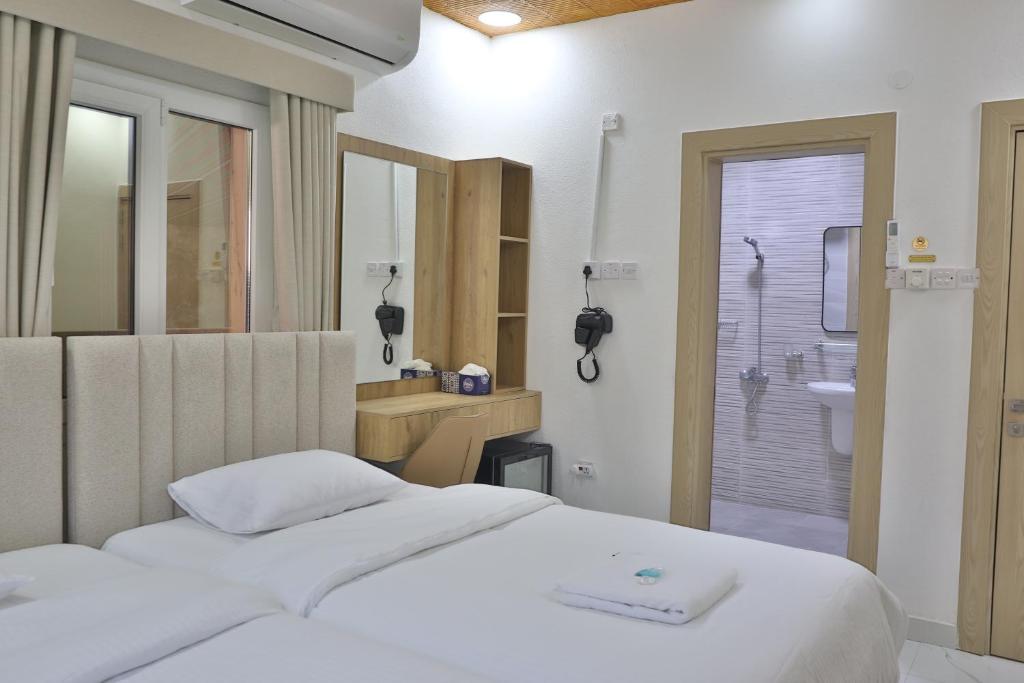 Postel nebo postele na pokoji v ubytování Darunique Inn