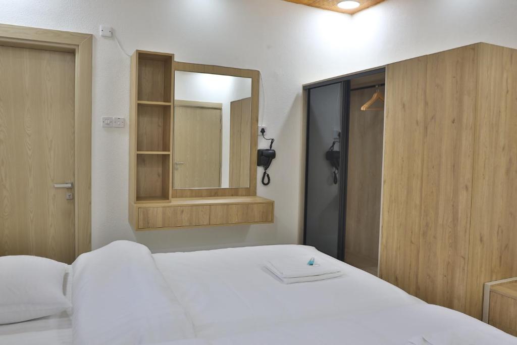 Postel nebo postele na pokoji v ubytování Darunique Inn