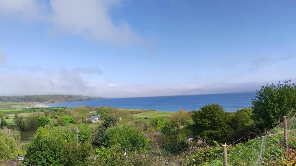 a view of the ocean from a hill at Seaside chalet in Ardmore with breathtaking views in Ardmore