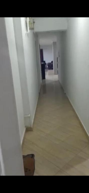 an empty hallway with white walls and a floor at شقة مفروشة فري in Cairo