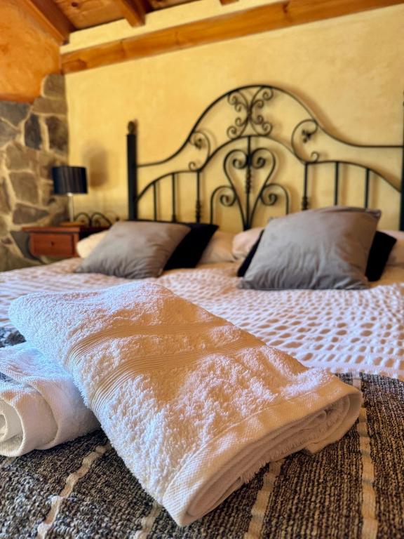 a bedroom with a large bed with a large headboard at Casa Obis in Muñeca