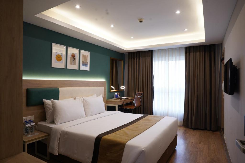 Postel nebo postele na pokoji v ubytování Sarovar Portico Kolkata