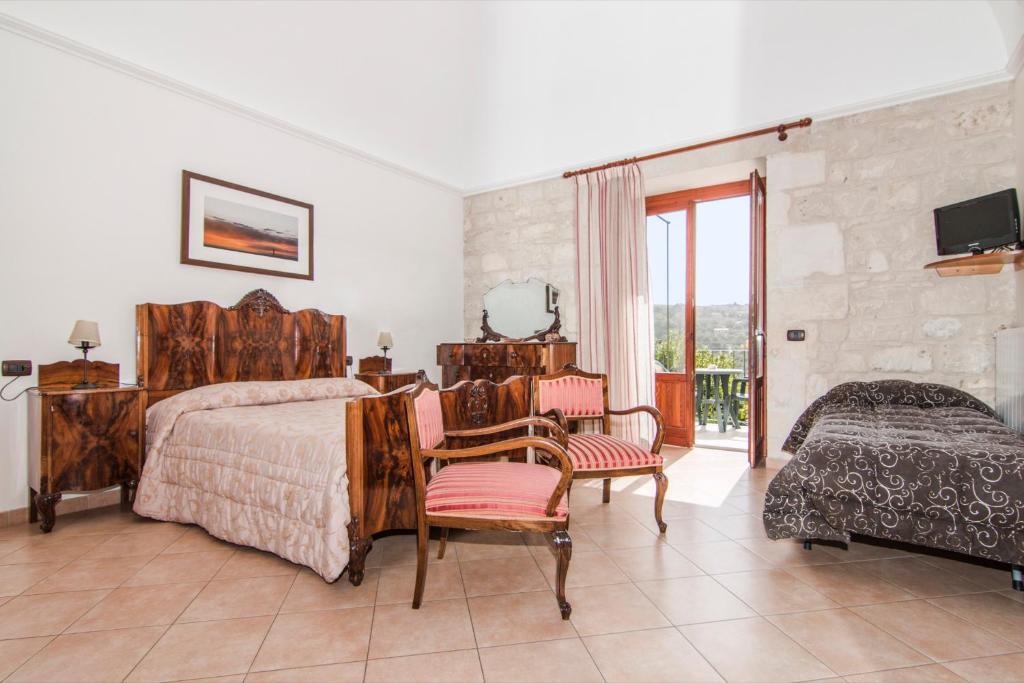 Postel nebo postele na pokoji v ubytování B&B Il Giardino Dei Mandarini