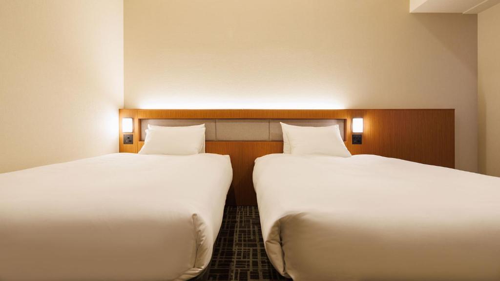 Postel nebo postele na pokoji v ubytování JR-East Hotel Mets Komagome