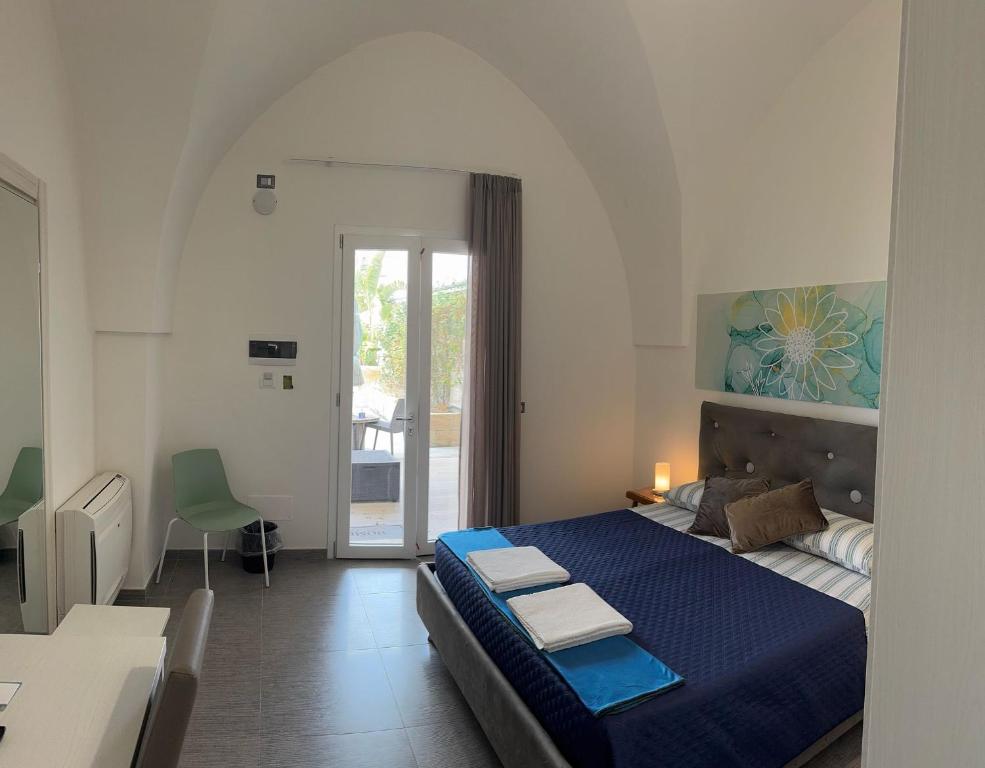 a bedroom with a large blue bed in a room at Dear Mary, B&B romantico vicino Lecce nel cuore del Salento in San Cesario di Lecce