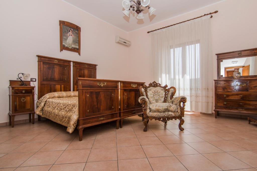 Postel nebo postele na pokoji v ubytování B&B Il Giardino Dei Mandarini