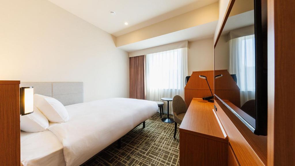Postel nebo postele na pokoji v ubytování JR-East Hotel Mets Komagome
