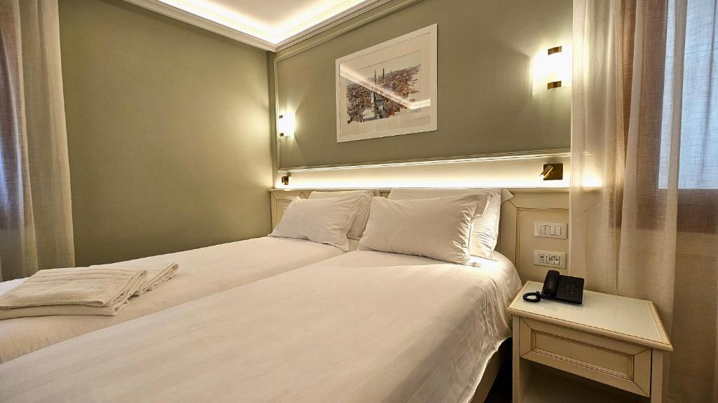 Postel nebo postele na pokoji v ubytování Hotel Guerrini