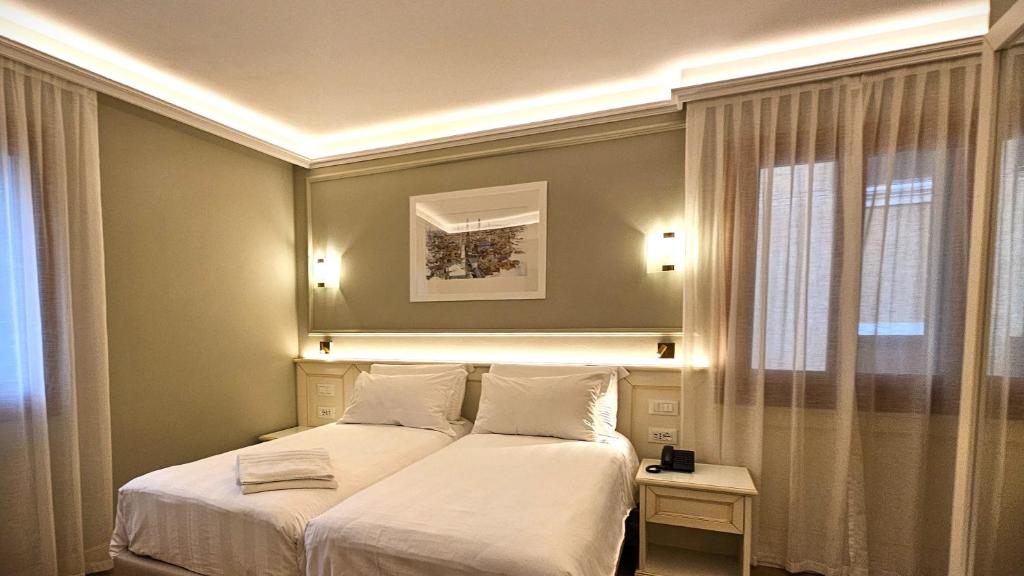 Postel nebo postele na pokoji v ubytování Hotel Guerrini