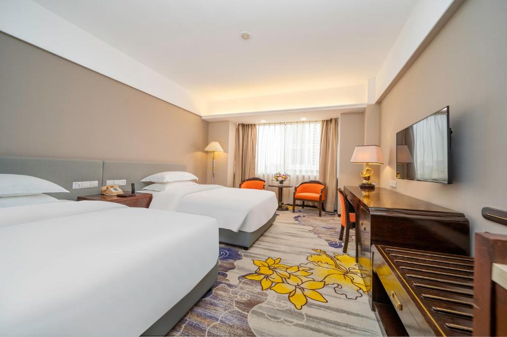 Postel nebo postele na pokoji v ubytování Zhongshan International Hotel
