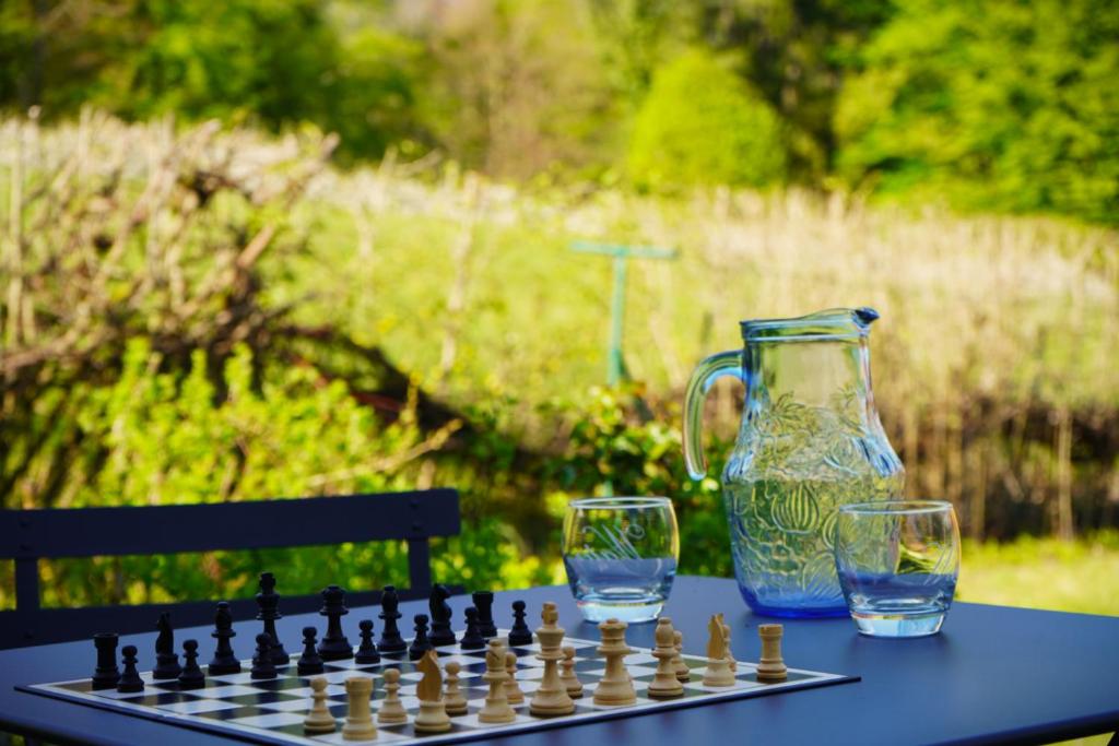 a chess board and two glasses on a table at Gite MontBlanc in Verrens-Arvey