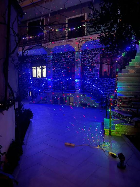 a room with blue lights on a stone wall at Vila Xhipe in Korçë