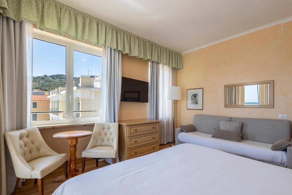 A television and/or entertainment centre at B&B HOTEL Diano Marina Palace