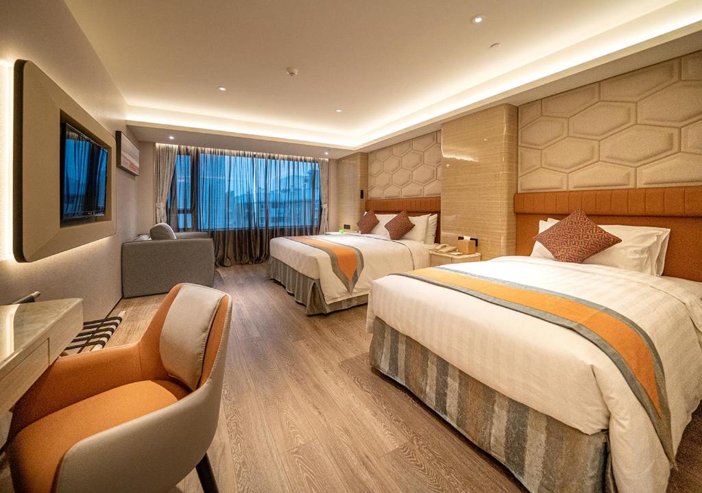 Postel nebo postele na pokoji v ubytování Hotel Golden Dragon
