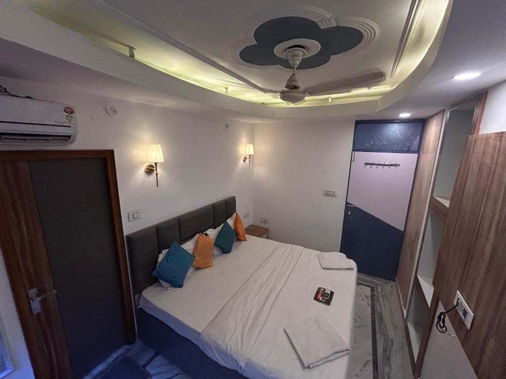 a small room with a bed and a ceiling at ZoukStayz in Rishīkesh