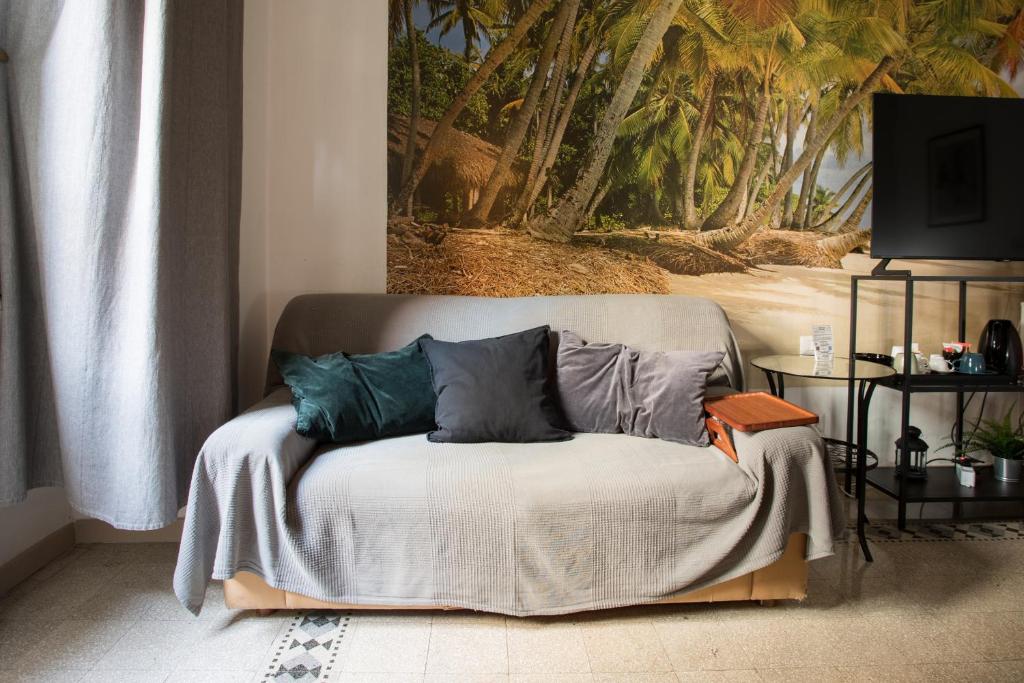 a couch with pillows on it in a living room at Da Alessia Per Dormire Al Coppedé in Rome