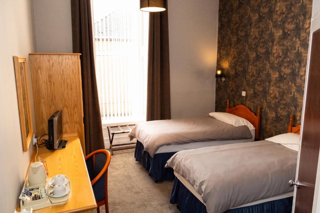 Postel nebo postele na pokoji v ubytování Station Hotel