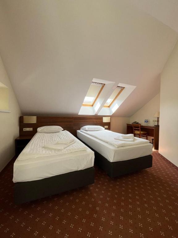 Postel nebo postele na pokoji v ubytování Memel Hotel