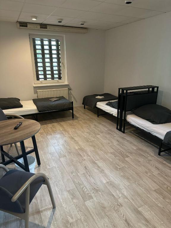 Postel nebo postele na pokoji v ubytování HH Hostels