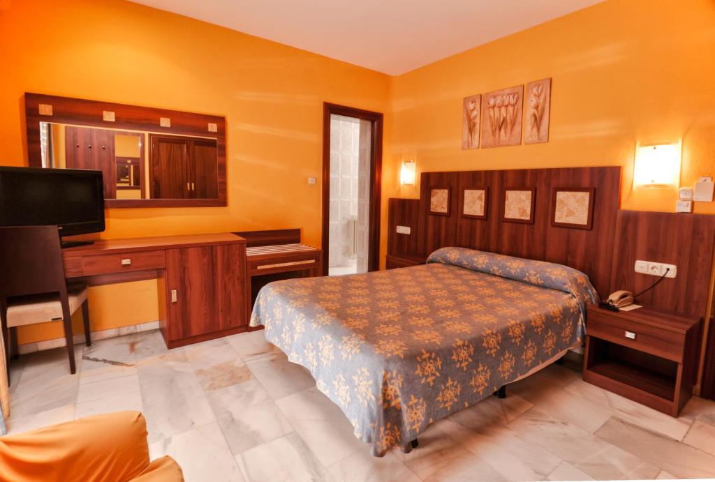 Postel nebo postele na pokoji v ubytování Hotel Nuevo Palas