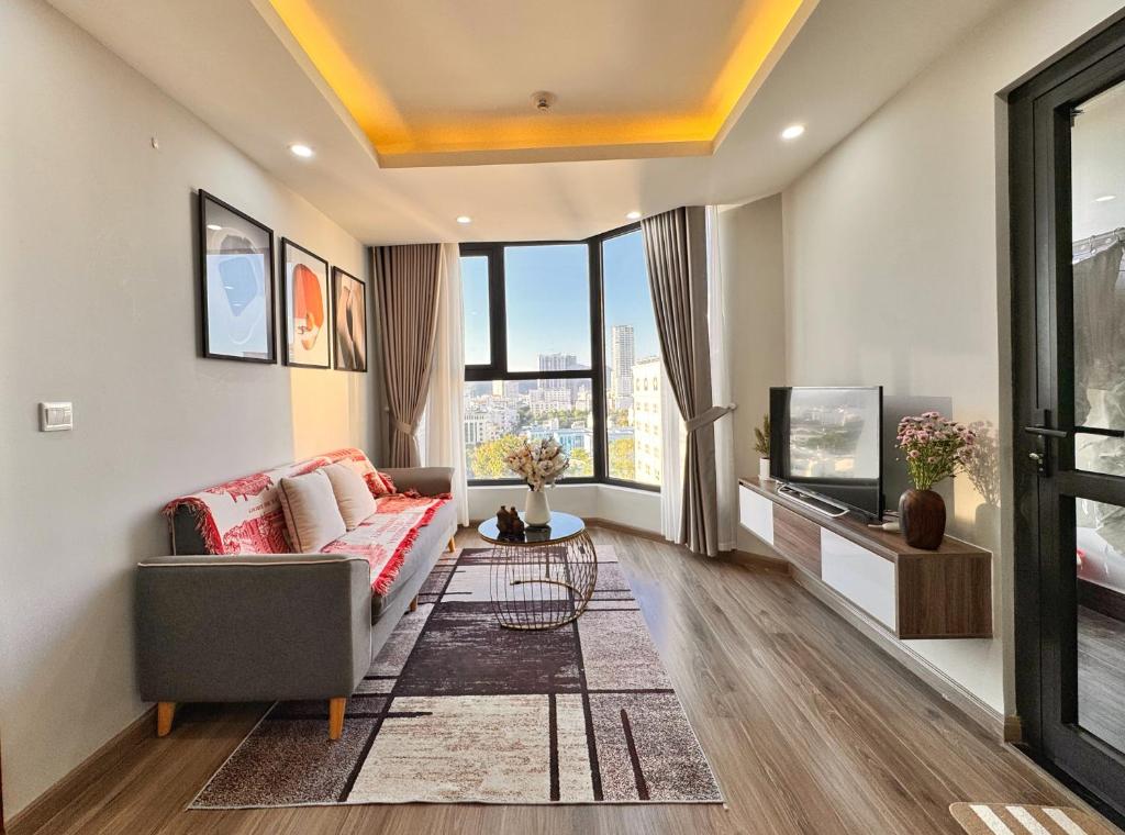 a living room with a couch and a tv at La Maison HUD building 2beds in Nha Trang