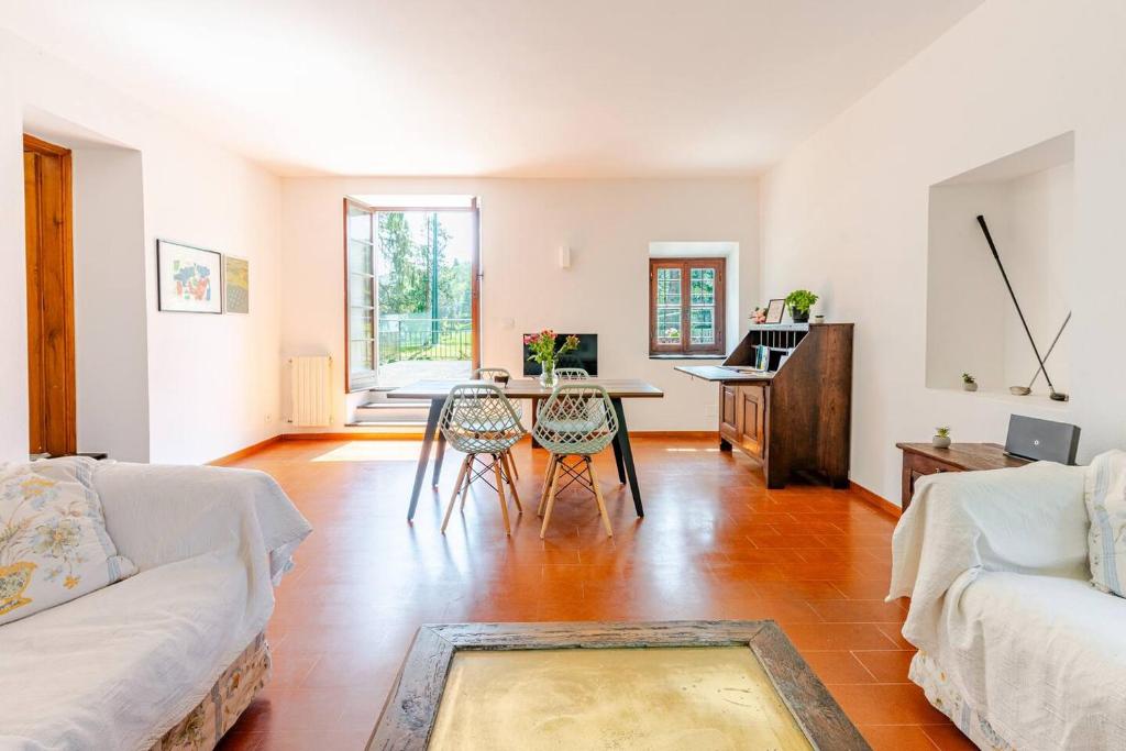 a living room with a table and chairs at Golf House - Valle Christi in Rapallo