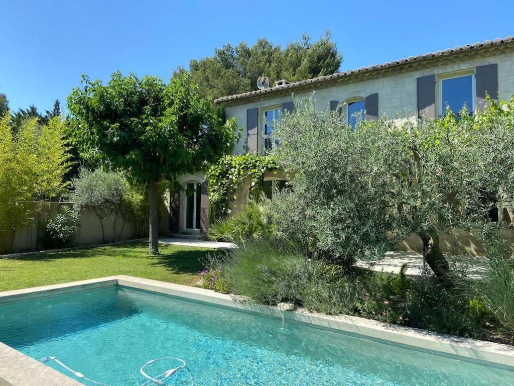 a house with a swimming pool in a yard at Mas Paradou, au coeur des Alpilles in Paradou