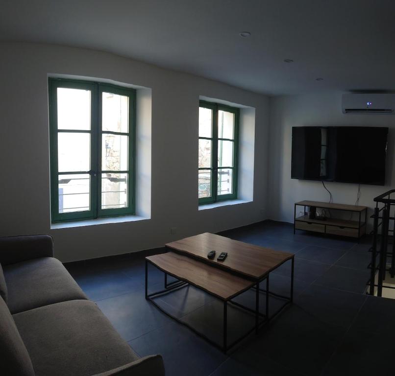 a living room with a couch and a coffee table at Maison cosy in Saint-Gilles