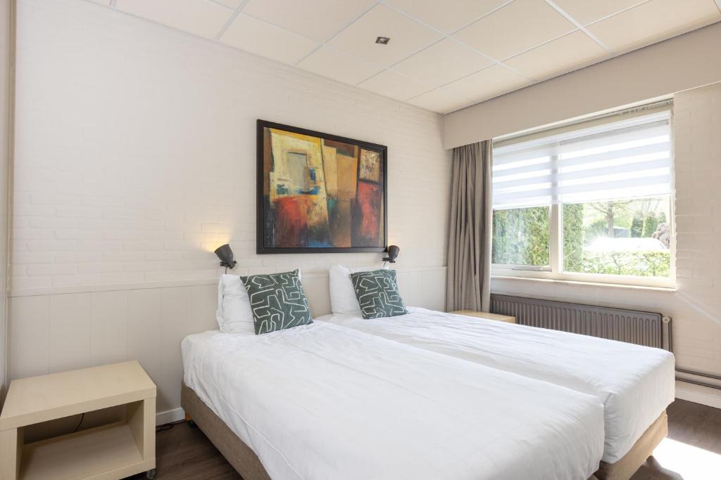 Een bed of bedden in een kamer bij Aparthotel Delden