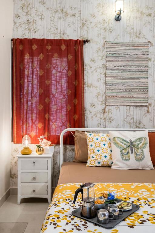 a bedroom with a bed with a tray of food on it at Gaia Homes in Bangalore