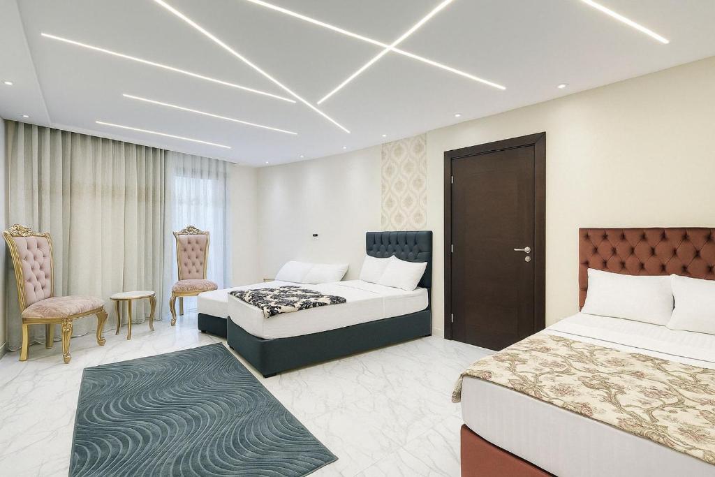 a hotel room with two beds and a chair at Beachfront Bliss Awaits You at Porto Said in Port Said