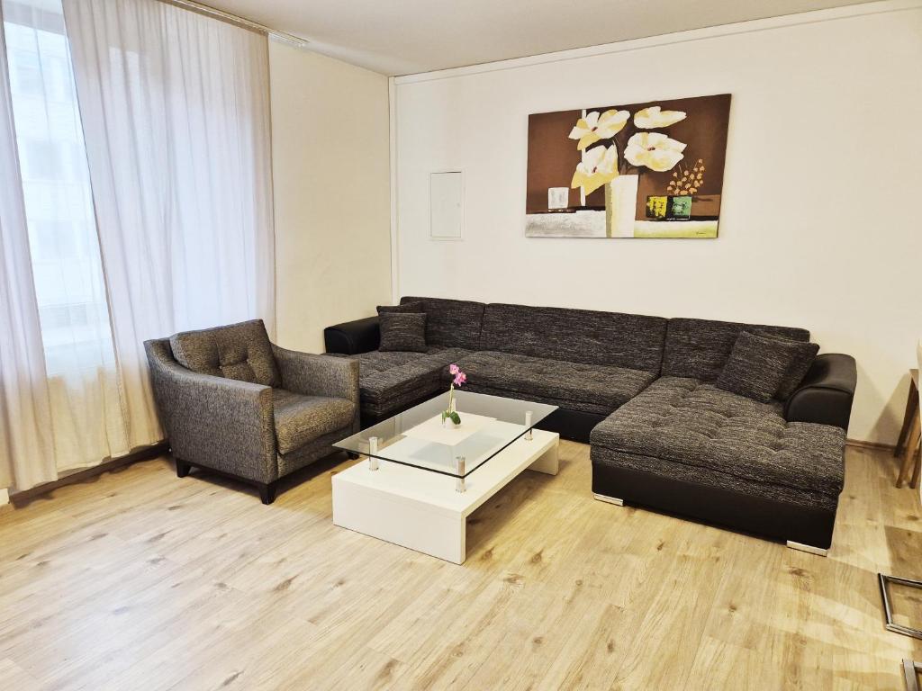 a living room with a couch and a coffee table at New City Center Stays 1 in Munich