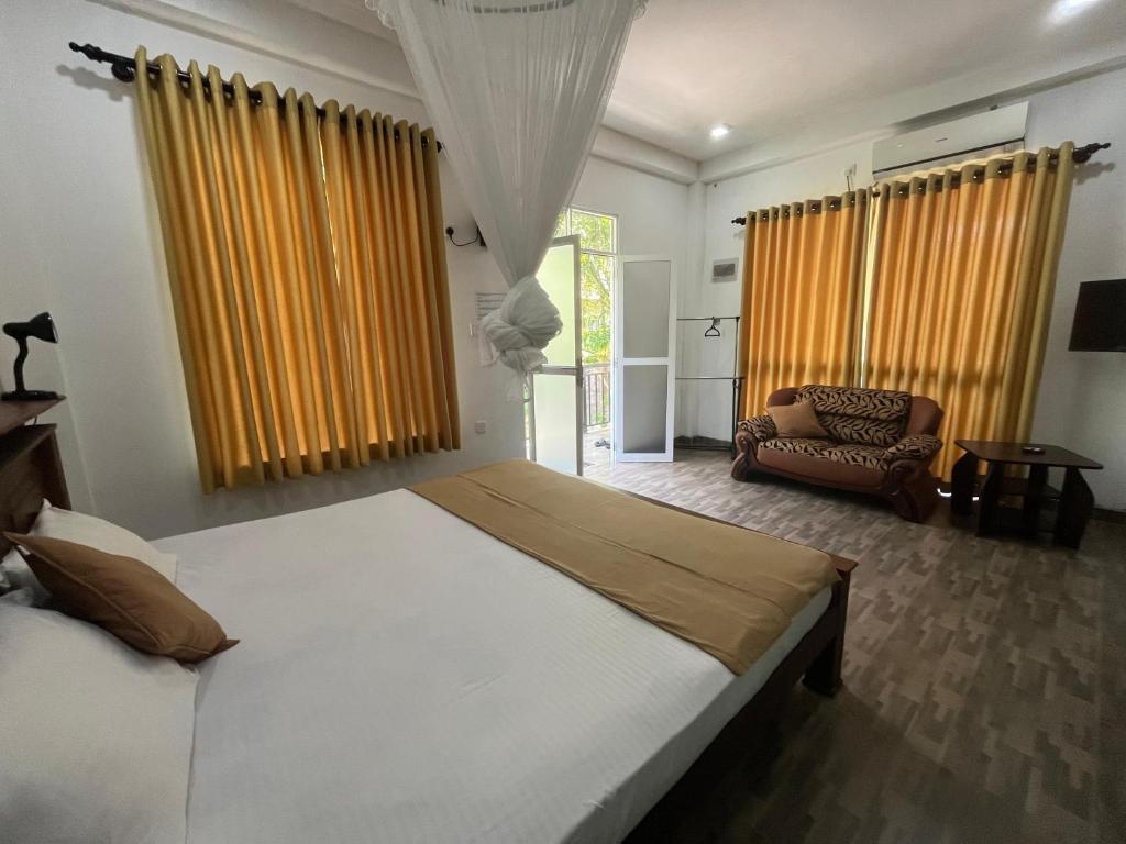 Ένα ή περισσότερα κρεβάτια σε δωμάτιο στο Wirges Villa - hikkaduwa